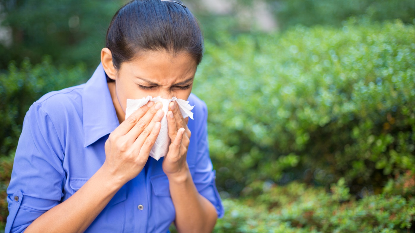 Supplements for Seasonal Allergies -- Woman Outside Sneezing