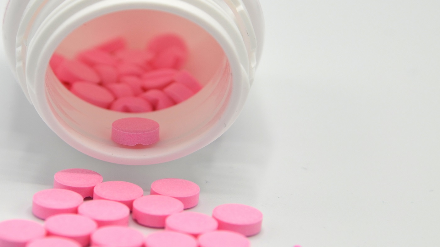 Warfarin Supplement Interactions -- bottle of pink warfarin tablets