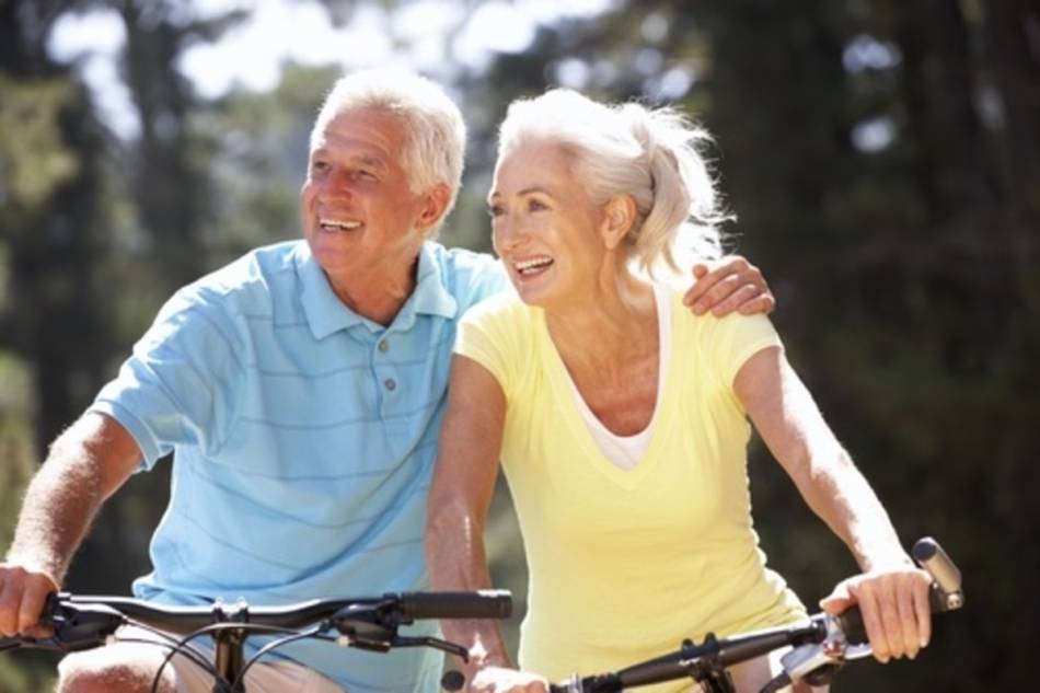 Senior Couple Riding Bicycles Smiling