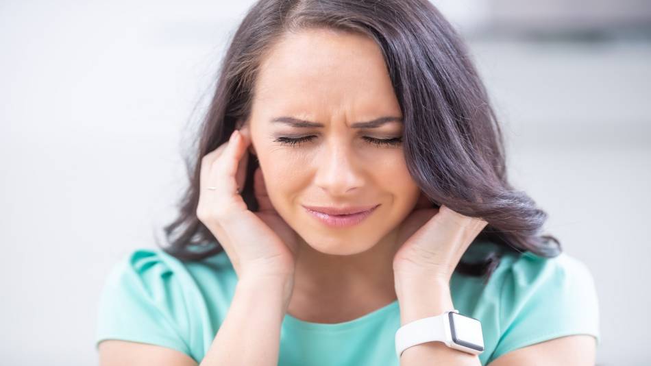Supplements for Tinnitus -- Woman Holding Her Ears 