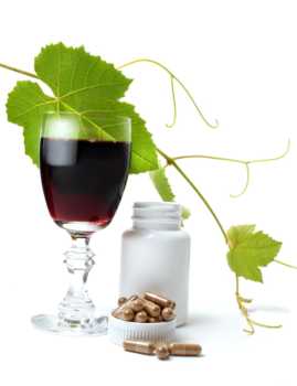 Glass of Wine and Resveratrol Supplement Bottle