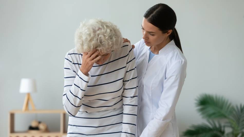 Young Woman Helping Elderly Woman Remain Upright