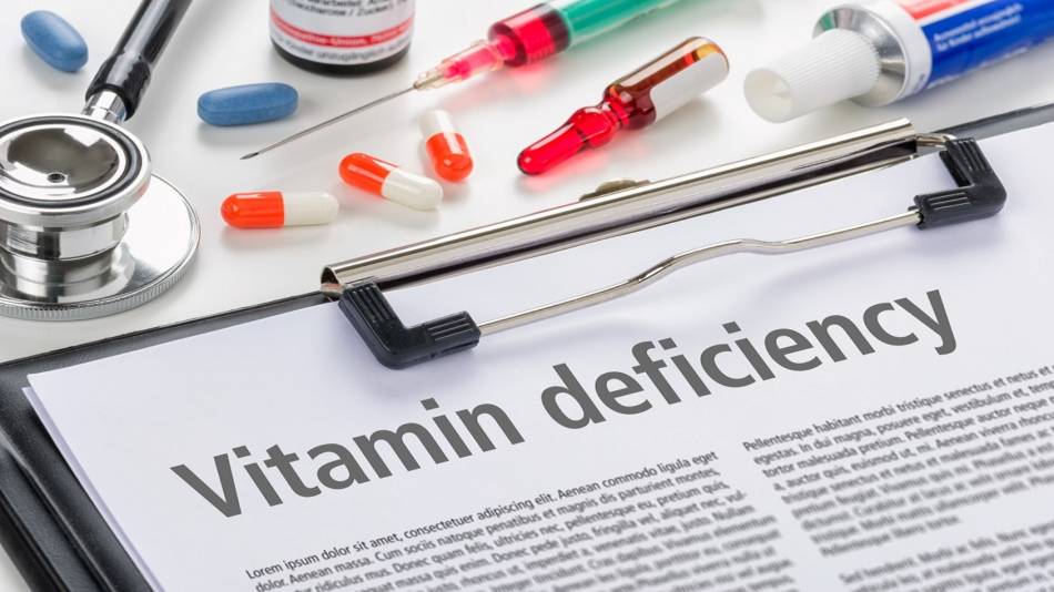 Vitamin Deficiency in Men and Women -- doctor's clipboard with information about vitamin deficiency