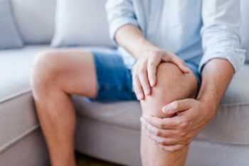 Man Holding Knee from Knee Pain