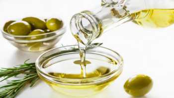 Health Benefits of Olive Oil -- pouring olive oil into a bowl