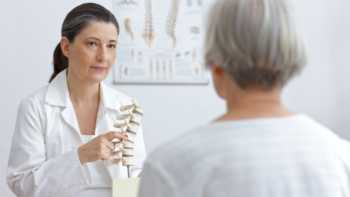 Doctor discussing osteoporosis with older female patient
