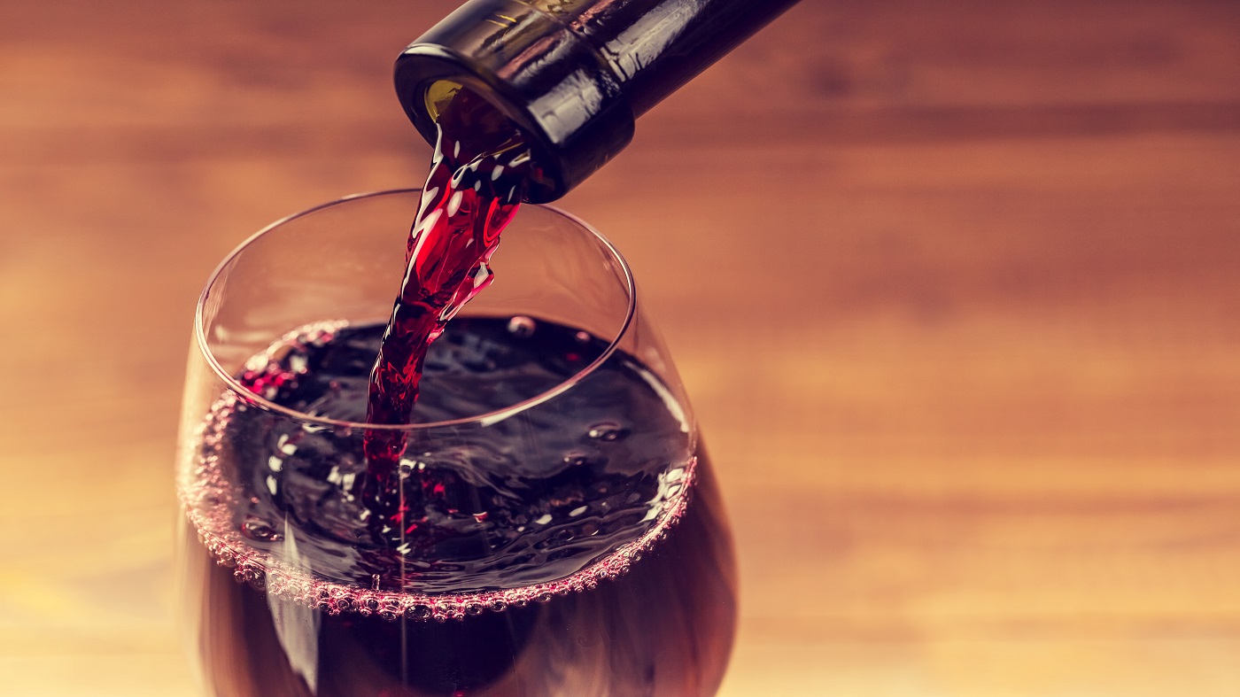 Resveratrol in Red Wine -- red wine pouring from bottle into glass