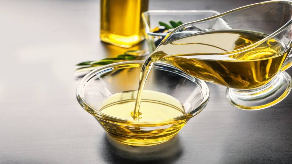 Health Benefits of Olive Oil -- Pouring Olive Oil Into a Bowl