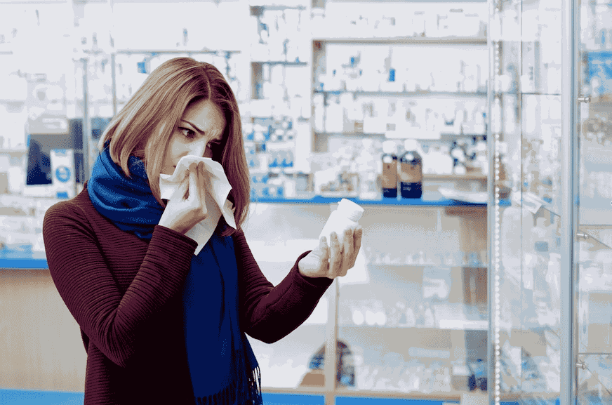 Woman with Cold Holding Pill Bottle