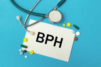 Sign Saying BPH with Tablets on Blue Background