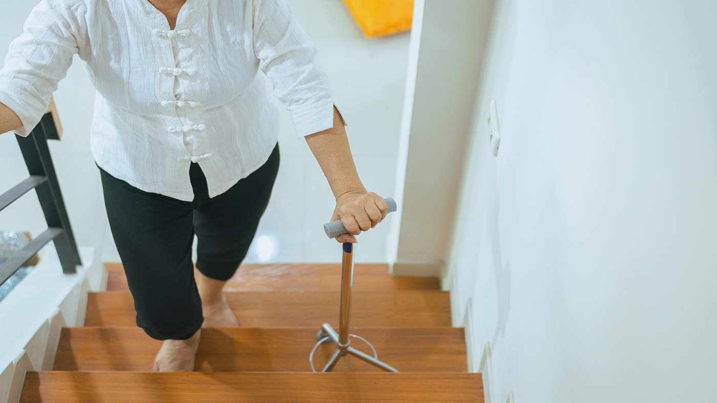 Supplements to Improve Balance & Reduce the Risk of Falls -- older woman walking up stairs 
