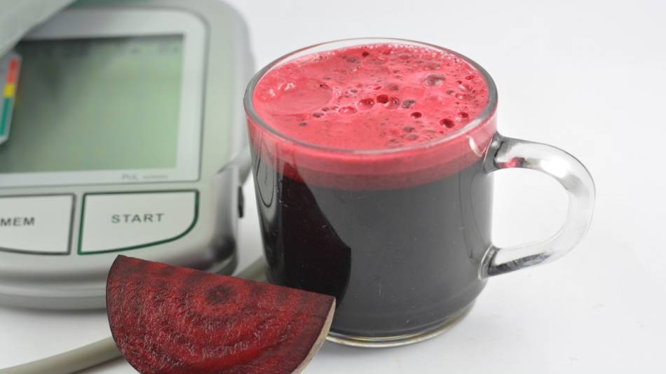 Beetroot Juice for Lowering Blood Pressure? -- Glass of beetroot juice and blood pressure monitor