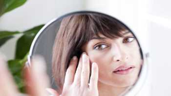 Phytoceramides for Aging Skin? -- woman looking at skin up close in mirror