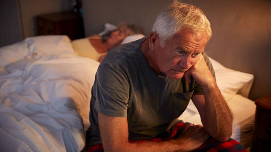Glycine for Sleep and Nighttime Urinary Frequency? -- Older Man Sitting on Bed, Awake at Night
