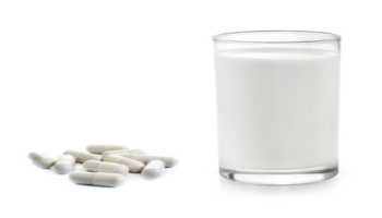 Milk and Probiotics Against White Background