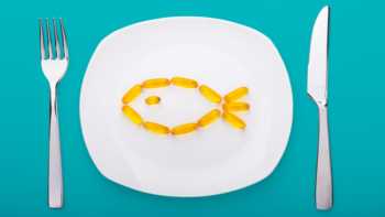 Best Way to Take Fish Oil -- fish oil capsules on plate with fork and knife