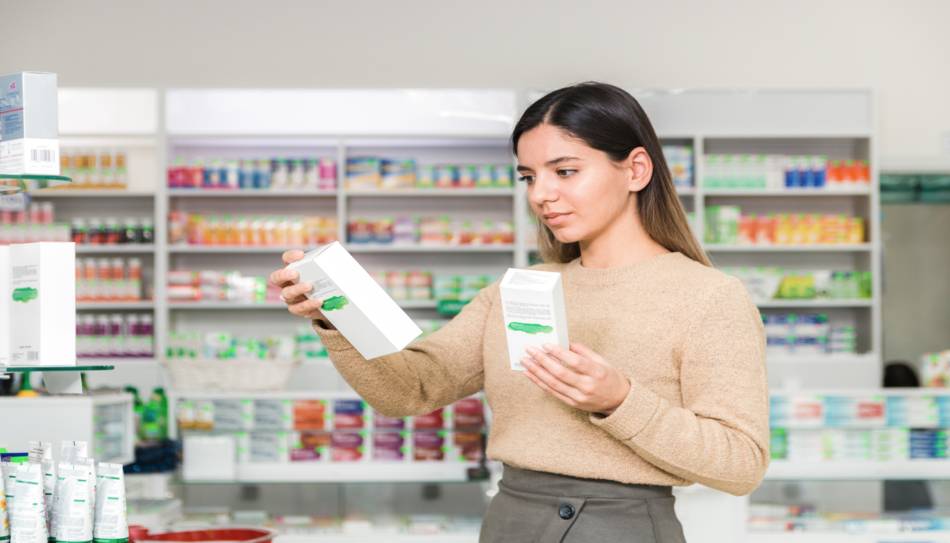 Woman Looking at Supplement Boxes
