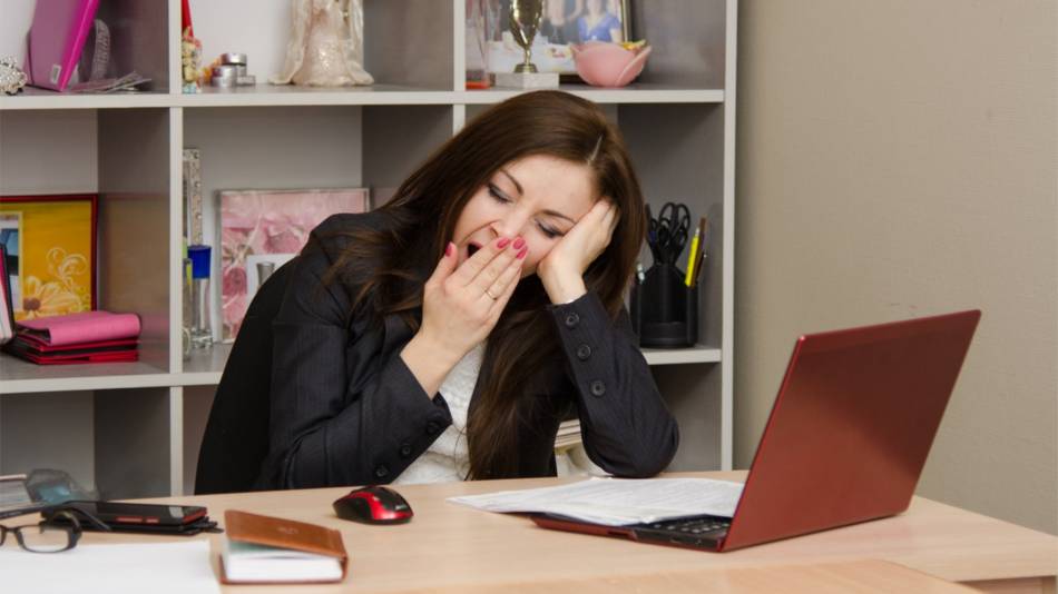 Supplements to Improve Energy and Decrease Fatigue -- tired woman yawning at desk