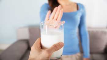 Milk Allergy & Getting Calcium -- woman rejecting glass of milk