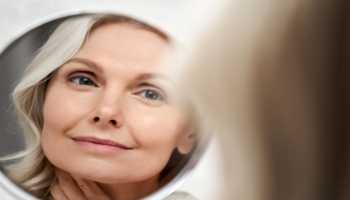 Elderly Woman Smiling Looking in Mirror