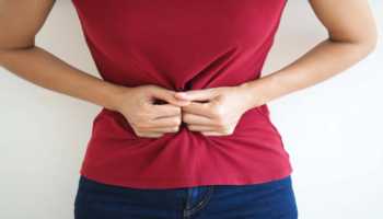 Woman Grabbing Stomach Due To Abdominal Discomfort