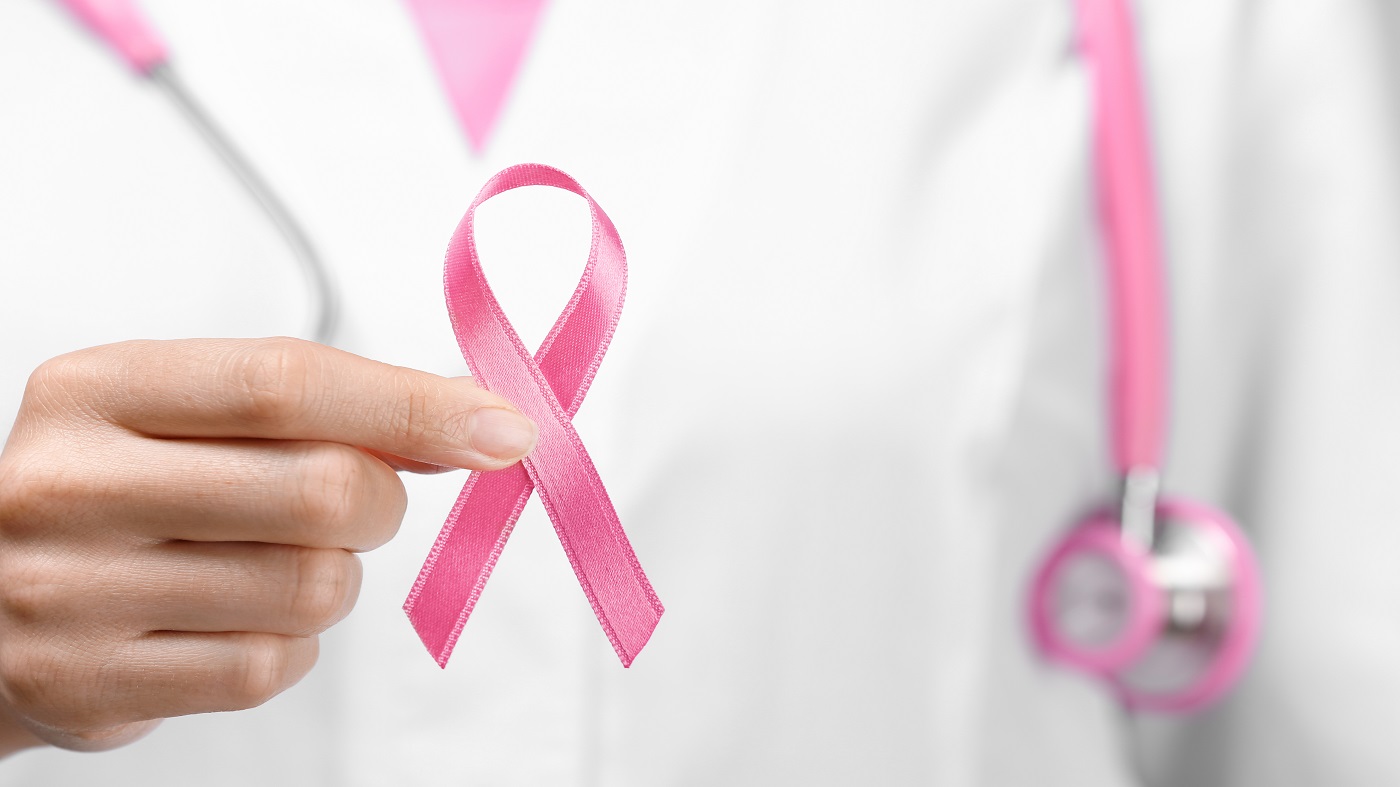 Supplements & Breast Cancer Risk -- doctor holding pink breast cancer awareness ribbon