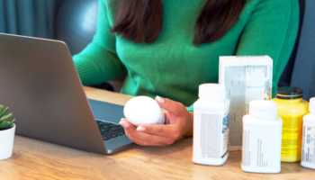 Woman Researching Supplements on Laptop