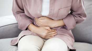 Which supplements can cause constipation? -- Woman with gastrointestinal pain