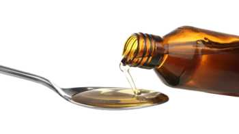 Fish Oil vs. Cod Liver Oil -- bottle of cod liver oil pouring into spoon