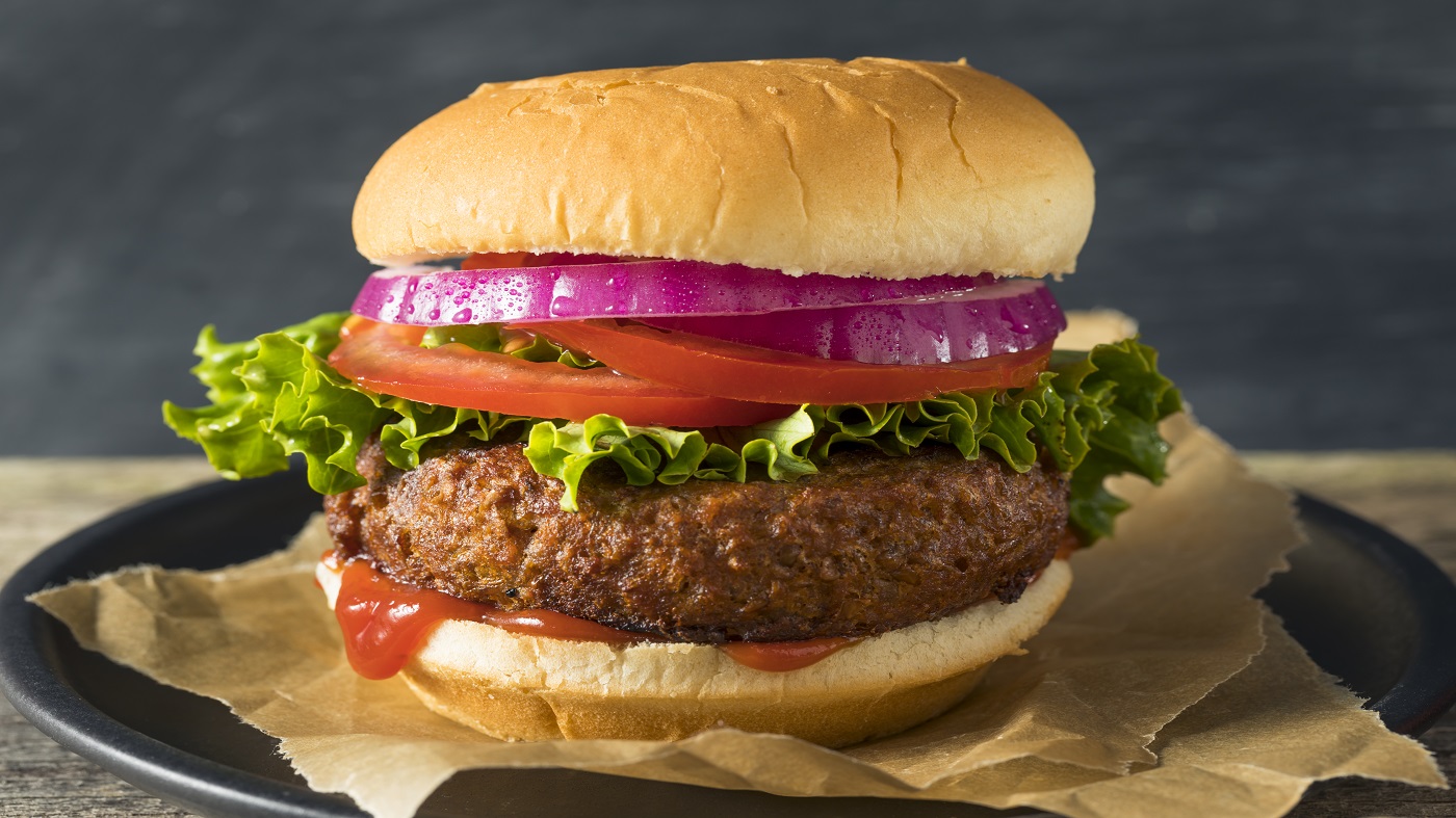 Beyond Burger vs. Impossible Burger: Nutrition, Vitamins & Minerals -- cooked plant-based burger on bun