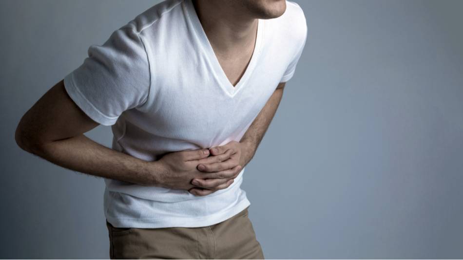 Supplements for peptic ulcer disease - young man with stomachache