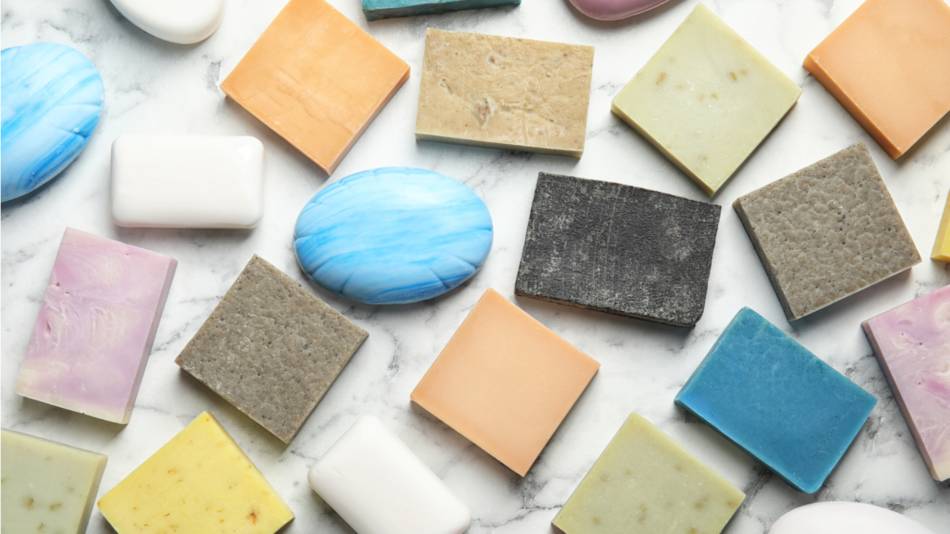 Different bars of soap on a marble countertop