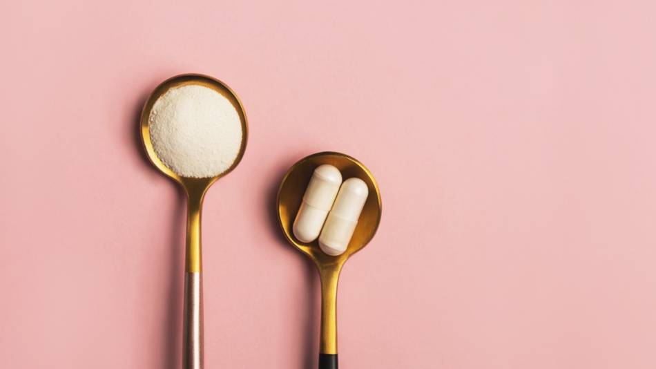 A spoon filled with collagen powder and another spoon filled with gelatin softgels