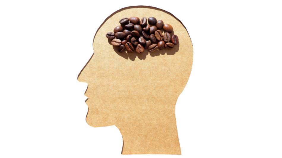 Silhouette of mans head with coffee beans in place of brain