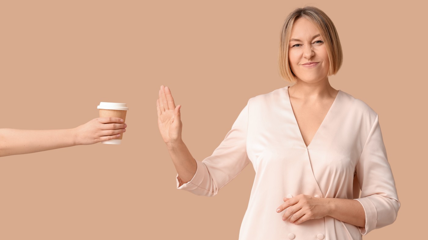 Woman saying no to a cup of coffee