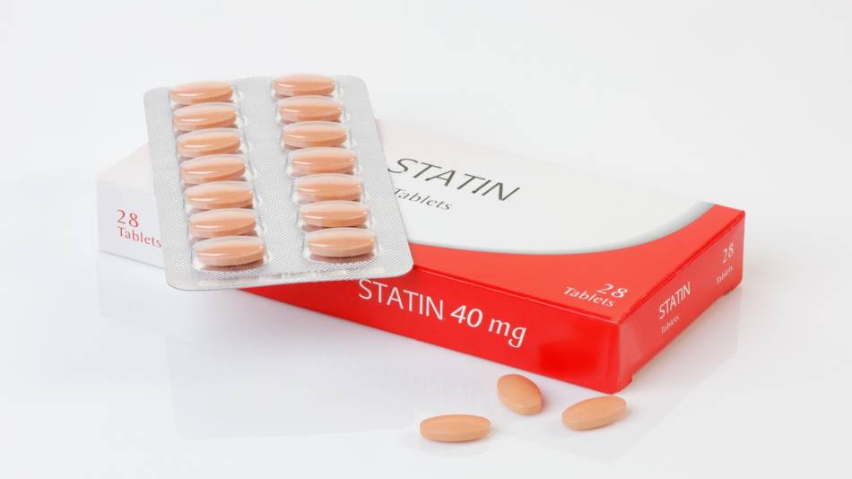 Statin Interactions With Supplements -- close-up of statin medication box and tablets