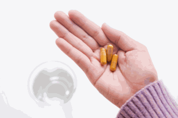 Curcumin Supplements in Hand Water in Background