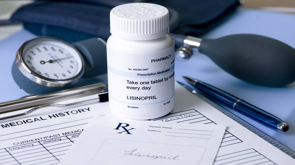 Lisinopril, ACE Inhibitors and Supplement Interactions -- prescription bottle of lisinopril on desk with blood pressure cuff