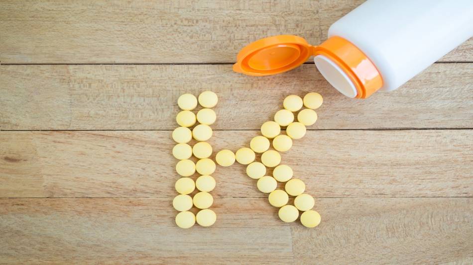 Vitamin K: MK-4 vs MK-7 -- vitamin K tablets in the shape of the letter 'K'