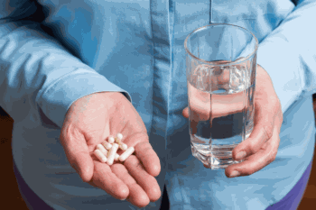 Supplements and Water in Hand